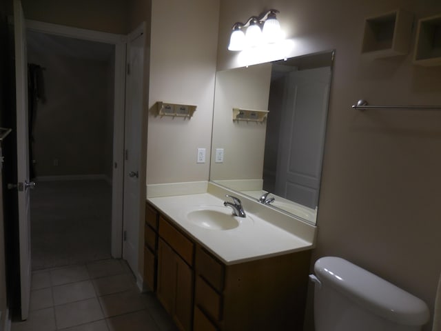 bathroom with tile patterned floors, vanity, and toilet