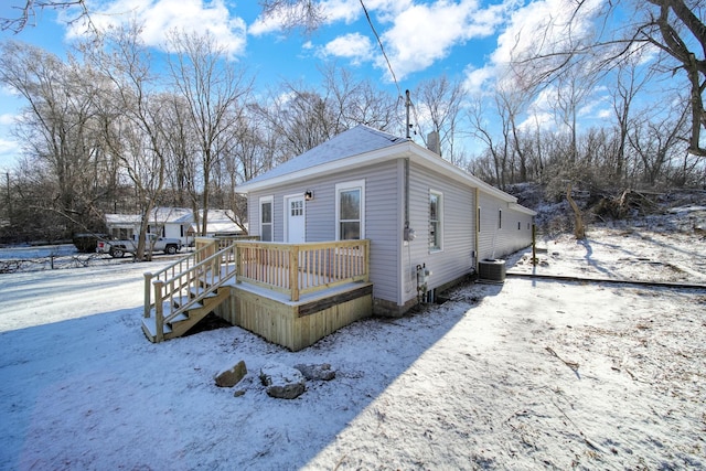 exterior space with central AC and a wooden deck