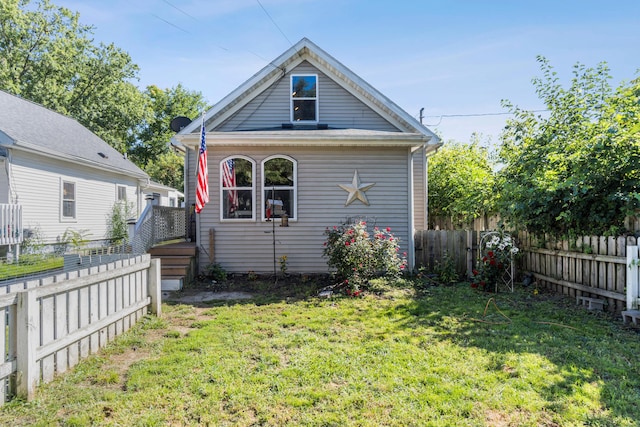 back of house featuring a yard