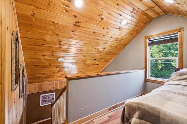 bedroom featuring lofted ceiling, hardwood / wood-style flooring, and wooden ceiling