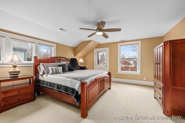 carpeted bedroom with ceiling fan and vaulted ceiling