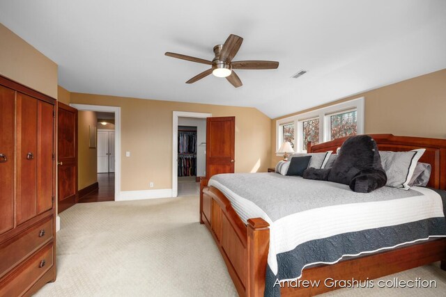 carpeted bedroom featuring ceiling fan, vaulted ceiling, and a closet