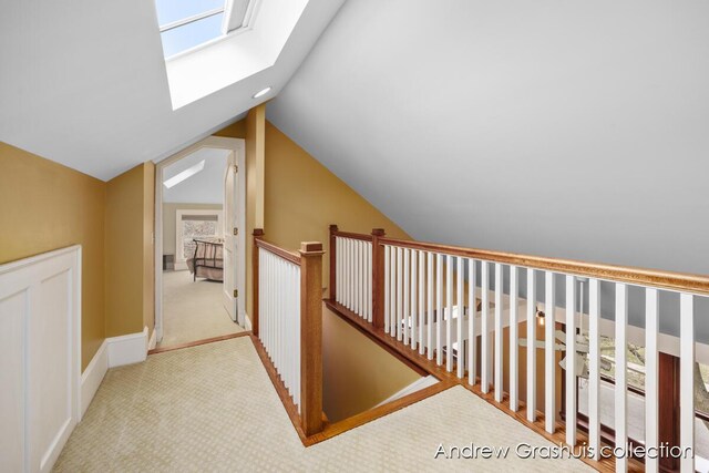 bonus room featuring light colored carpet and vaulted ceiling with skylight