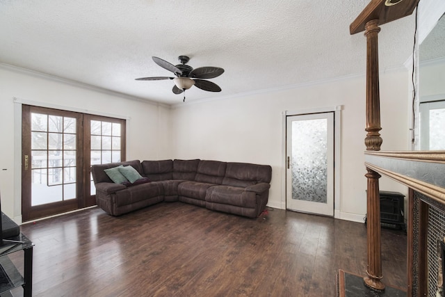 living room featuring ornamental molding, a textured ceiling, ceiling fan, and dark hardwood / wood-style flooring