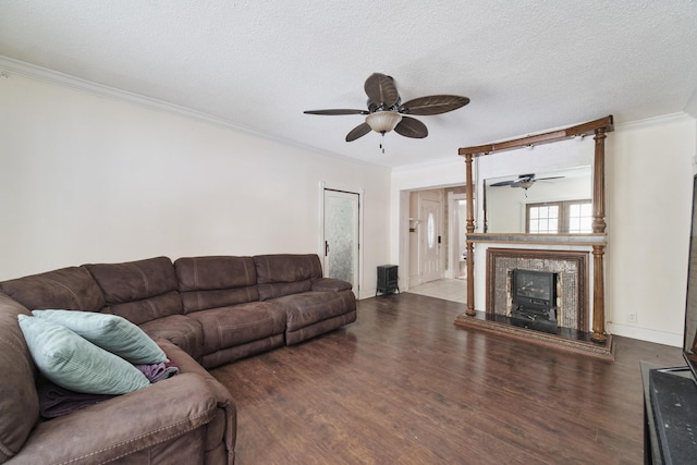 living room with a textured ceiling, ceiling fan, crown molding, and dark hardwood / wood-style floors