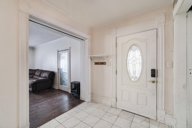 foyer entrance featuring a textured ceiling, crown molding, and light hardwood / wood-style flooring