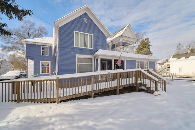 view of snow covered rear of property