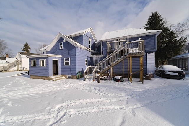 snow covered property with a wooden deck