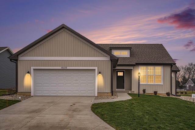 view of front facade featuring a garage and a yard