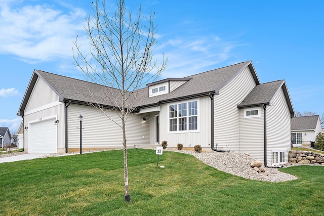 view of front of house with a front yard, concrete driveway, roof with shingles, and an attached garage