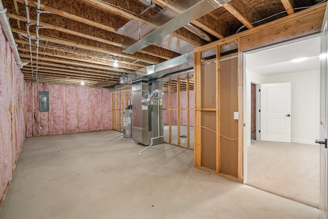 unfinished basement featuring water heater, heating unit, and electric panel