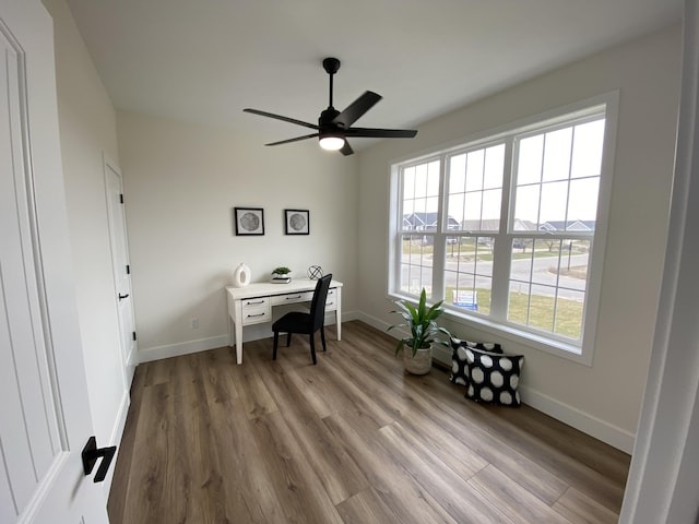 office featuring baseboards, wood finished floors, and a ceiling fan