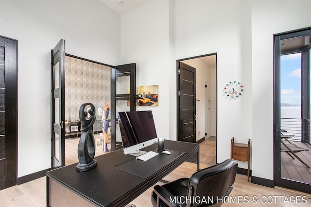 office area with light hardwood / wood-style floors