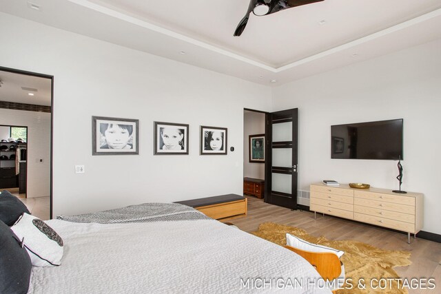 bedroom with ceiling fan and hardwood / wood-style flooring