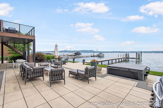 view of patio with a boat dock, a water view, an outdoor hangout area, and a hot tub