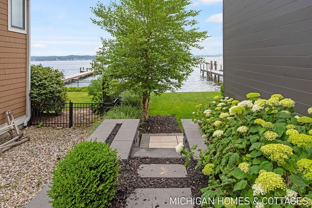 view of yard featuring a boat dock and a water view