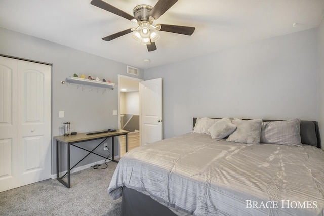 carpeted bedroom with ceiling fan and a closet