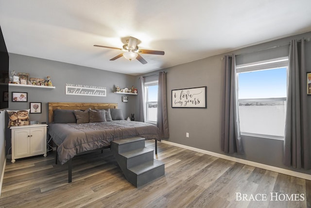 bedroom with ceiling fan and wood-type flooring