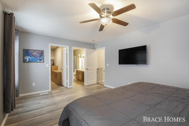 bedroom featuring ensuite bathroom, ceiling fan, and hardwood / wood-style flooring