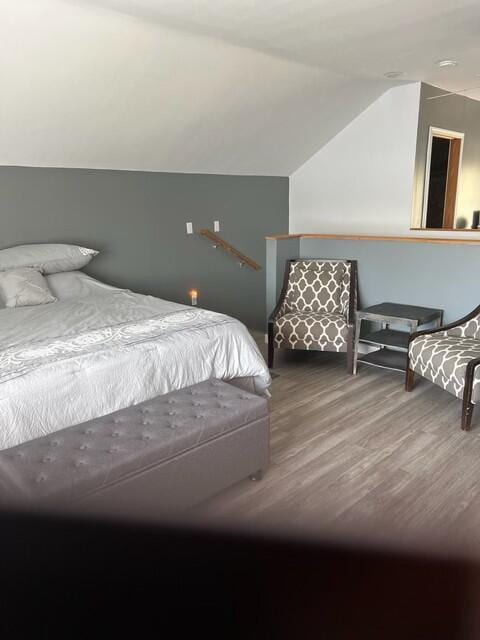 bedroom featuring hardwood / wood-style floors and lofted ceiling