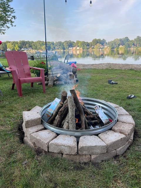 view of yard with a water view and a fire pit