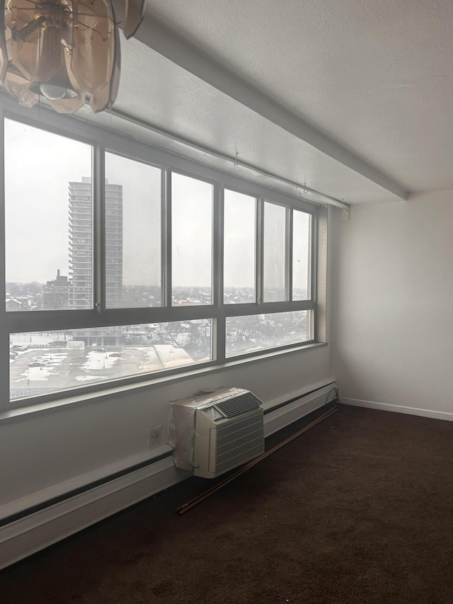 unfurnished sunroom featuring a wall mounted air conditioner and baseboard heating