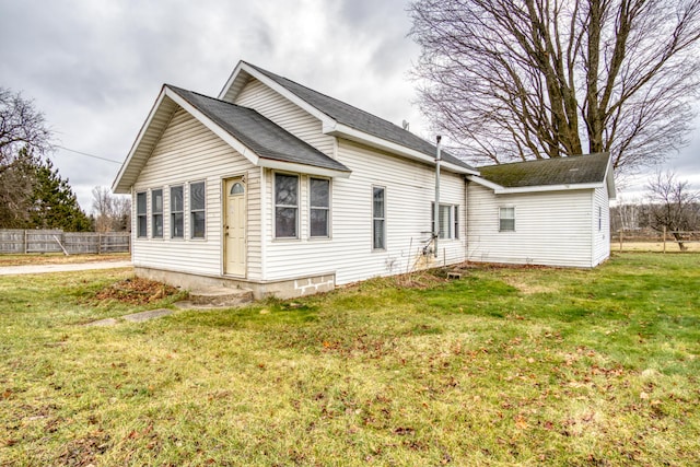 rear view of property featuring a yard