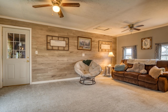 carpeted living room featuring a textured ceiling, ceiling fan, and ornamental molding