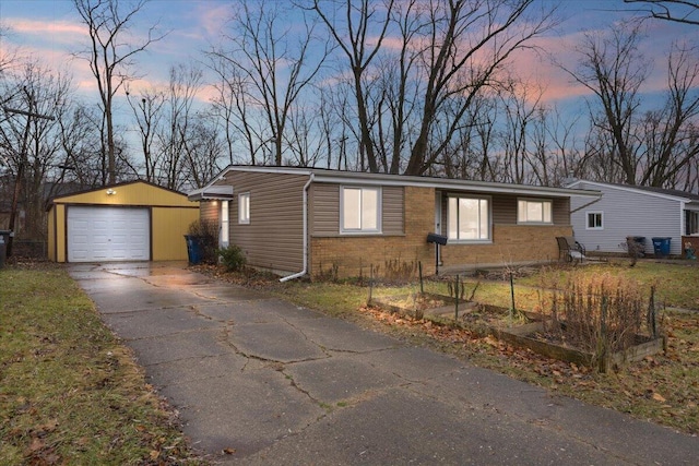 view of front of house with a garage and an outbuilding