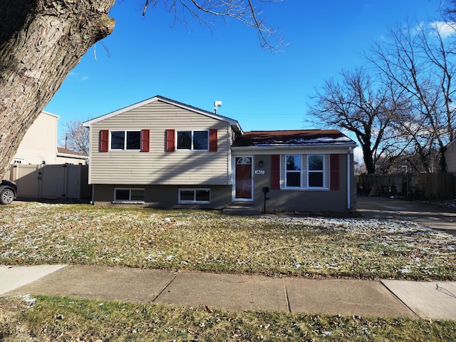 tri-level home with a front yard