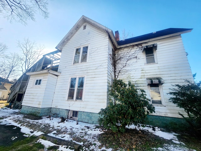 back of property with a chimney