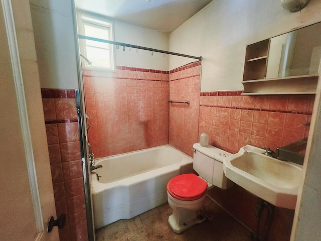 full bath featuring a wainscoted wall, bathing tub / shower combination, a sink, tile walls, and toilet