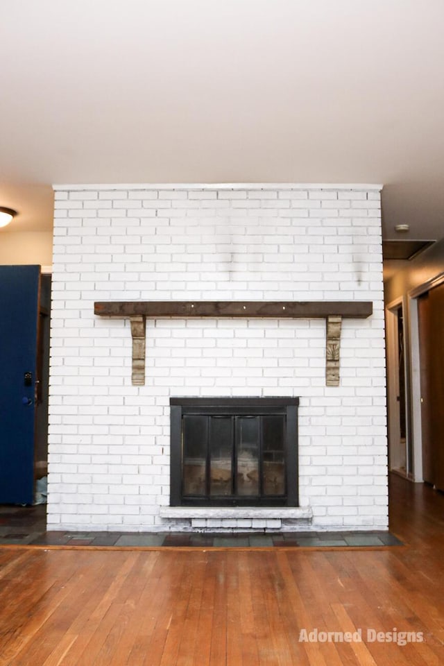 room details with a fireplace and hardwood / wood-style flooring