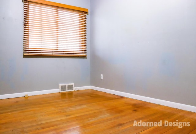 spare room featuring hardwood / wood-style floors