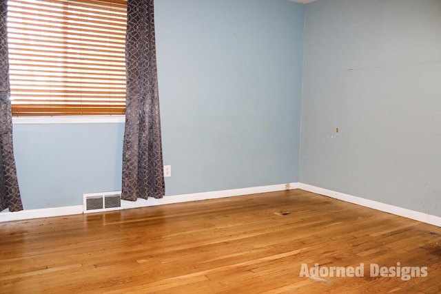 unfurnished room with hardwood / wood-style flooring