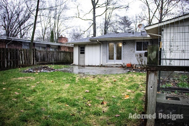 rear view of house with a yard