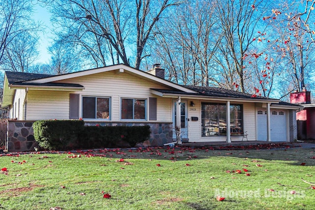 single story home with a garage and a front lawn