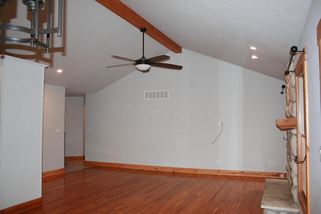 unfurnished living room featuring ceiling fan, vaulted ceiling with beams, and wood-type flooring