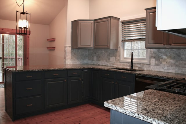 kitchen featuring sink, stone countertops, decorative backsplash, and hardwood / wood-style flooring