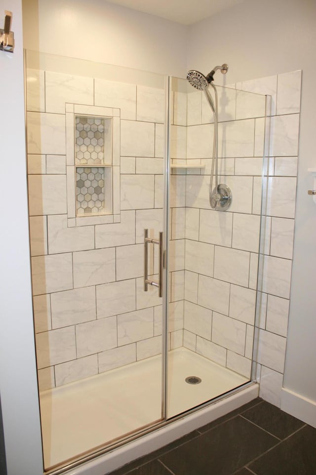 bathroom featuring an enclosed shower and tile patterned flooring