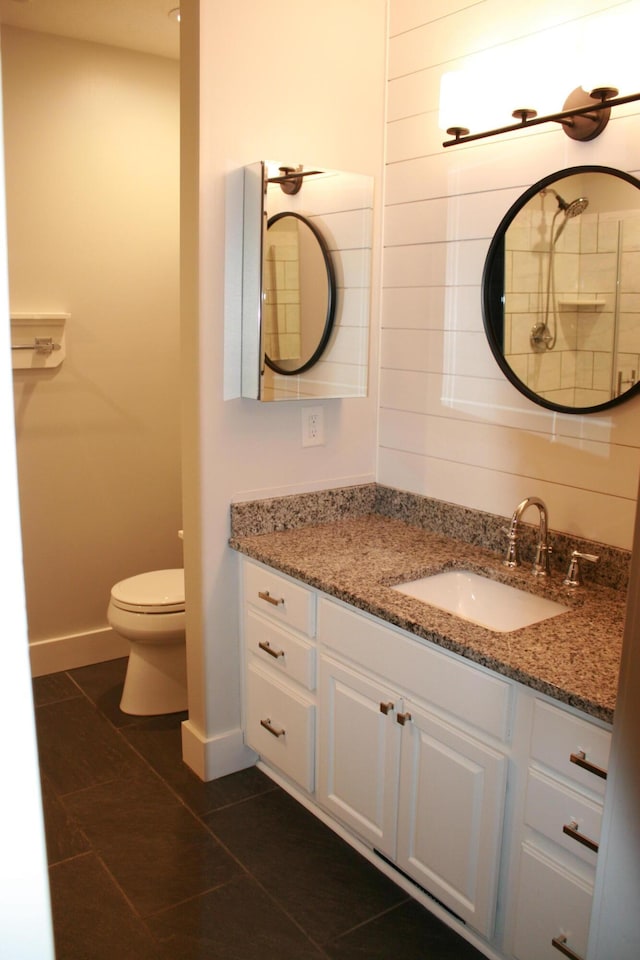 bathroom with toilet, tile patterned floors, and vanity