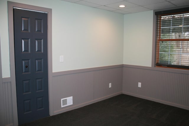 entrance foyer featuring dark carpet