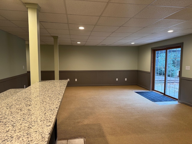 carpeted empty room with a paneled ceiling