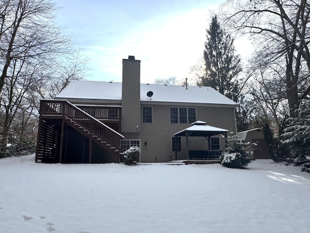 snow covered rear of property featuring a gazebo and a wooden deck