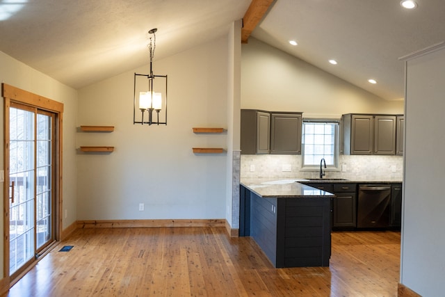 kitchen featuring tasteful backsplash, dishwasher, sink, light stone counters, and light hardwood / wood-style flooring