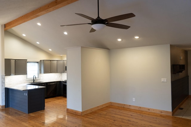 kitchen with beamed ceiling, tasteful backsplash, sink, and light hardwood / wood-style flooring