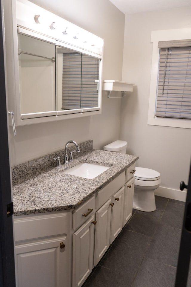 bathroom with tile patterned floors, vanity, and toilet