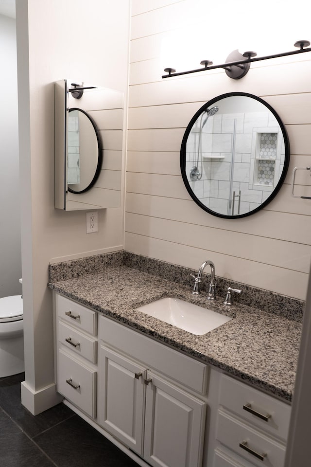 bathroom with vanity, tile patterned flooring, and toilet