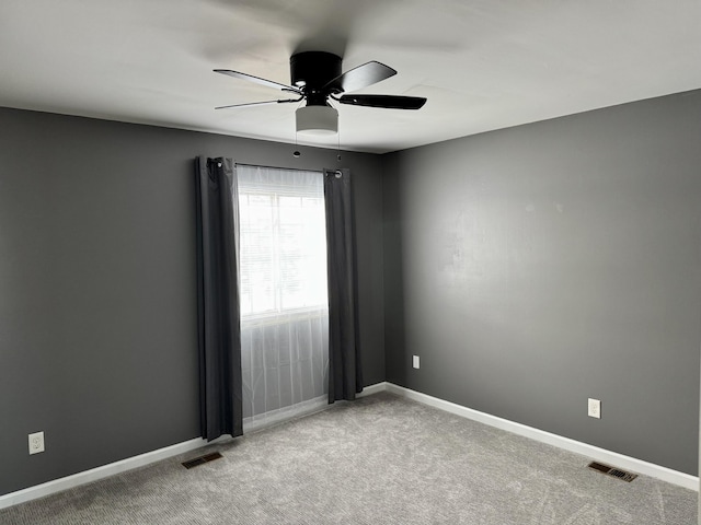 carpeted spare room featuring ceiling fan