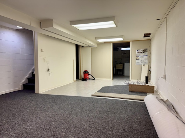 basement with light carpet, washer / clothes dryer, and radiator